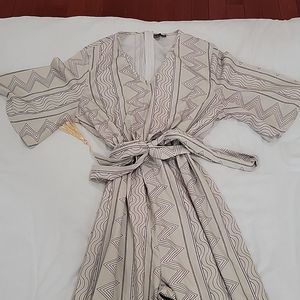 Printed jumpsuit with tie at waist / tassel detail at hem of pants
